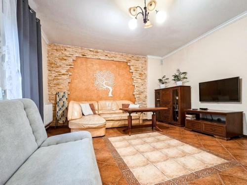 a living room with a couch and a tv at Gunram Mazury in Okowizna
