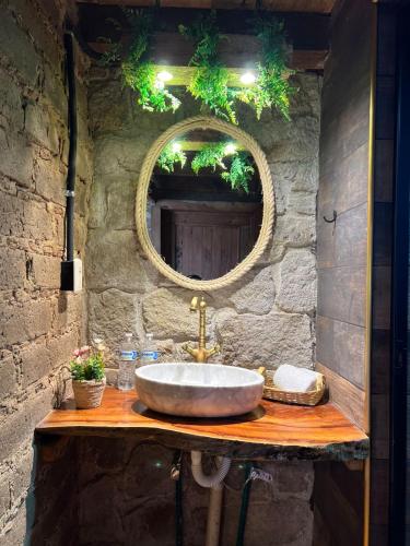 a bathroom with a sink and a mirror at Cabañas el lago in Zacatlán