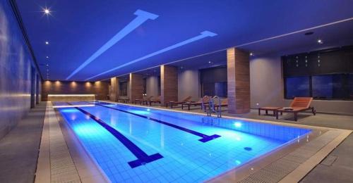 a large swimming pool in a hotel at night at ToTi Kalman in Zlatibor