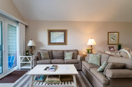a living room with a couch and a table at 1304 Pelican Watch Villa in Seabrook Island