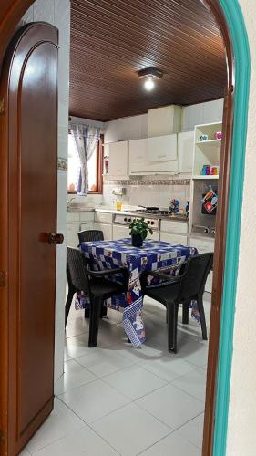 a kitchen with a table and chairs in a kitchen at Hostal Casalé Usaquén Embajada de Mexico in Bogotá