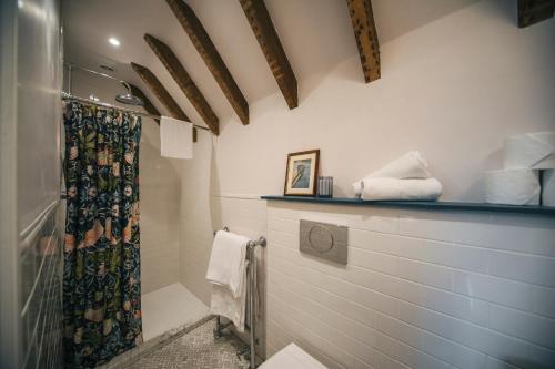 a bathroom with a shower with a shower curtain at The Blue House in Portree