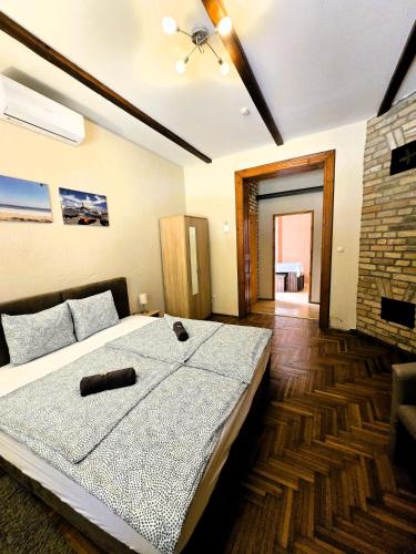 a bedroom with a large bed and a fireplace at Mediterrán Vendégház in Kecskemét