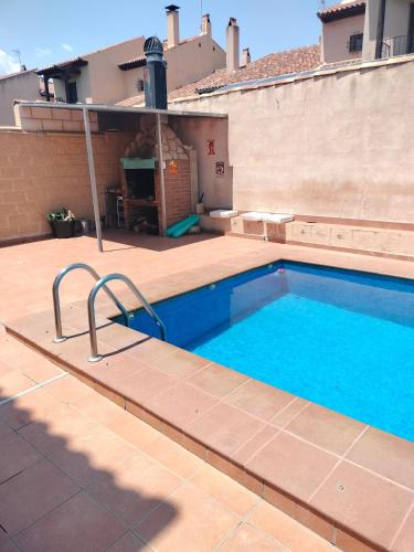 a swimming pool on the side of a house at La Casa de las Nereidas in Cuenca