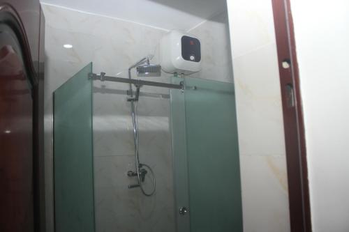 a bathroom with a shower with a camera on the wall at D31 Residency by Elianaelio Hotels in Uyo