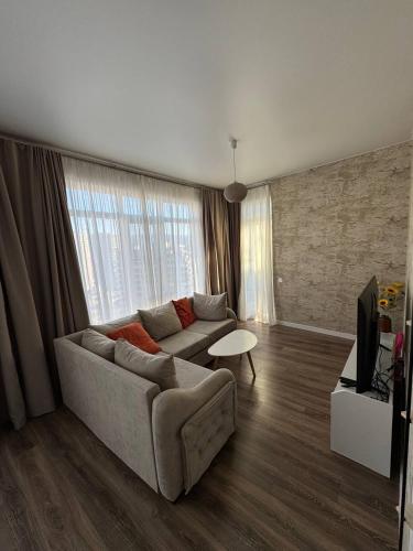 a living room with a couch and a table at Luxury Suites White Sails in Batumi