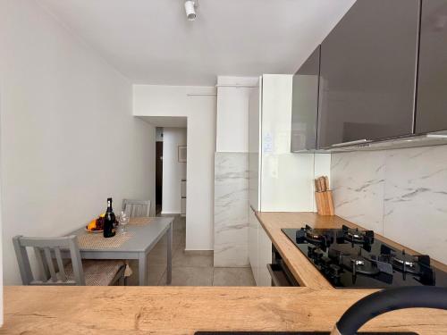 a kitchen with a table and a stove top oven at Cozy Stay City Center Apartment Warsaw in Warsaw