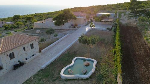 an aerial view of a house with a tub in a yard at Terra Lucis Mountain Residences in Agios Leon