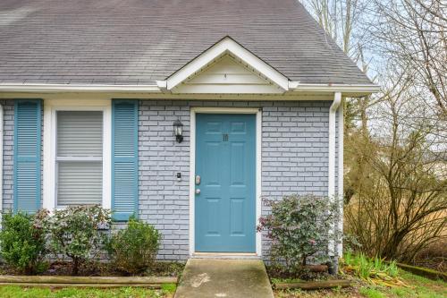 a house with a blue door in front of it at Lots of Hot Spots & Activities Near This Townhome in Cartersville