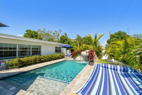 a swimming pool in front of a house at The Palm Oasis at Clearwater in Clearwater