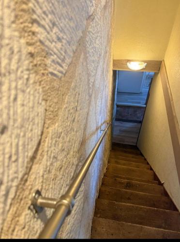a hallway with a staircase with a railing and a stair case at Maison Cosy Saumur in Saumur
