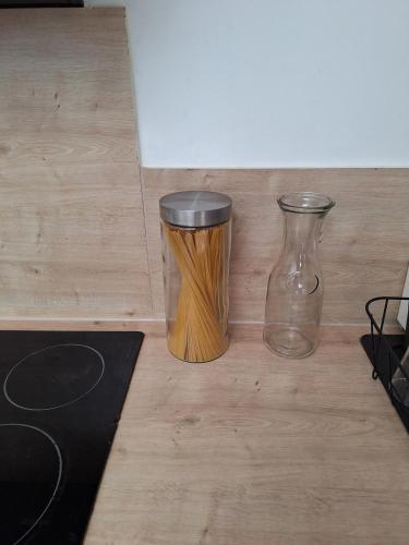 two glass vases sitting on a wooden floor at Maison Cosy Saumur in Saumur