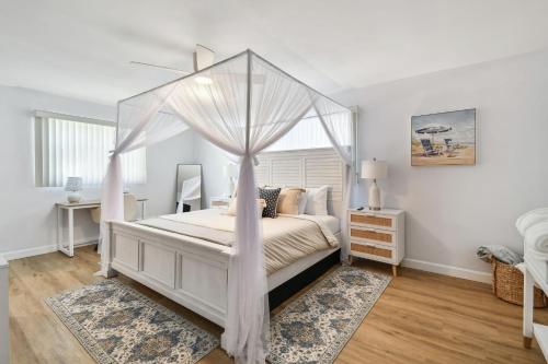 a bedroom with a bed with a canopy at The Palm Oasis at Clearwater in Clearwater