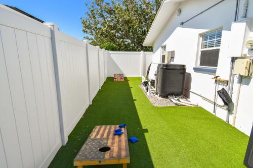 a backyard with a bench and a fence at The Palm Oasis at Clearwater in Clearwater