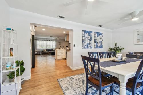 a dining room and living room with a table and chairs at The Palm Oasis at Clearwater in Clearwater