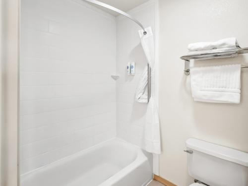 a white bathroom with a shower and a toilet at Comfort Inn & Suites O'Fallon - St Louis Area in O'Fallon
