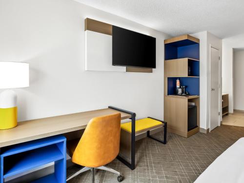 a room with a desk and a yellow chair at Comfort Inn & Suites O'Fallon - St Louis Area in O'Fallon