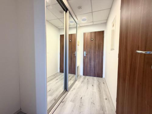 an office hallway with a glass door and wooden floors at Balu Apartments in Prague