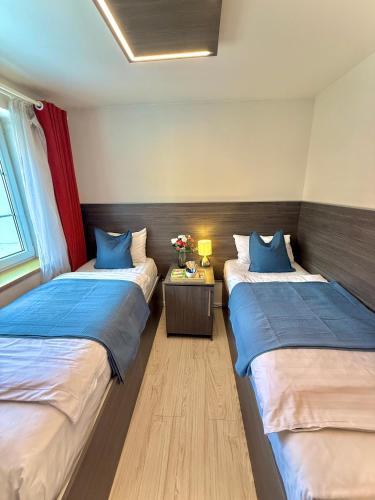 a room with two beds and a table with flowers at Royal Villas in Prague