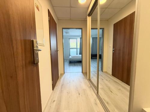 an empty hallway with a mirror in a room at Balu Apartments in Prague