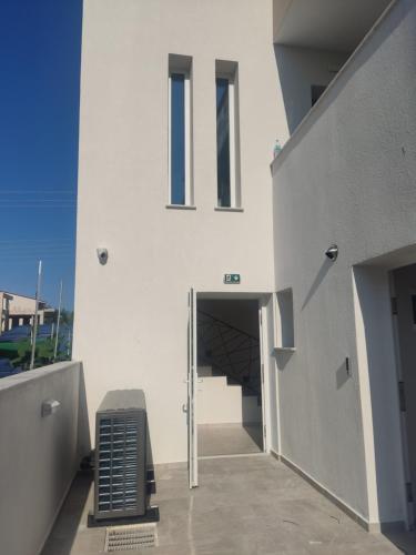 a white building with a ramp leading into a tunnel at EriZen Jacuzzi suites in Keramotí