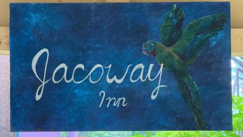 a sign that saysagonasyim with a green bird on it at Jacoway Inn in Calibishie
