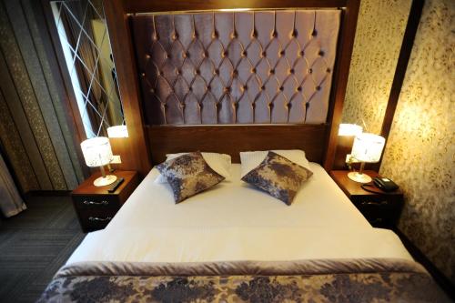 a bedroom with a bed with two pillows on it at Vurna Butik Hotel in Trabzon