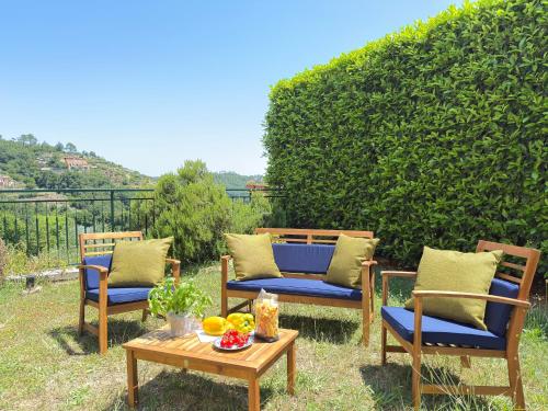 a group of chairs and a table with fruit on it at Garden & Seaview - Relax for Bikers and Families in Bardino Vecchio