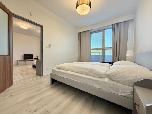 a bedroom with a large bed and a large mirror at Balu Apartments in Prague