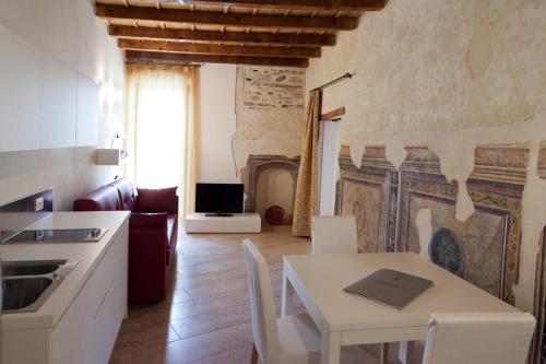 eine Küche, ein Esszimmer mit einem Tisch, eine Küche und ein Wohnzimmer in der Unterkunft Residenza Madonna Verona in Verona