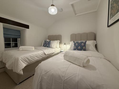 En eller flere senge i et værelse på Woodman's Cottage