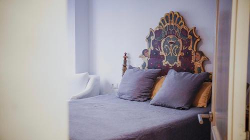 a bed with an ornate headboard in a bedroom at Força Old Town in Girona