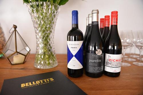 four bottles of wine sitting on a table at Cascades Motor Inn in Dubbo