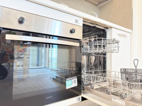 a dishwasher with two dishes inside of it at Garden & Seaview - Relax for Bikers and Families in Bardino Vecchio