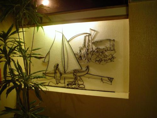 a drawing of a sail boat on a wall at Soltejo in Vila Nova da Barquinha