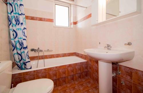 a bathroom with a sink and a toilet and a tub at #Taygetos view# in Sparti