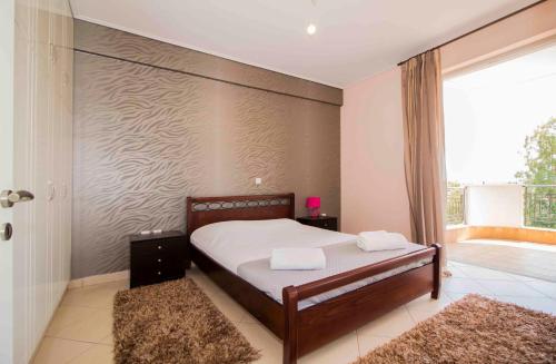 a bedroom with a bed with two towels on it at #Taygetos view# in Sparti
