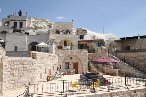 an old stone building with stairs and an umbrella at Zen Cappadocia House in Goreme