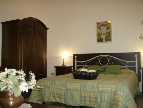 a bedroom with a bed with green pillows at B&B Centro Storico 900 in Palmi