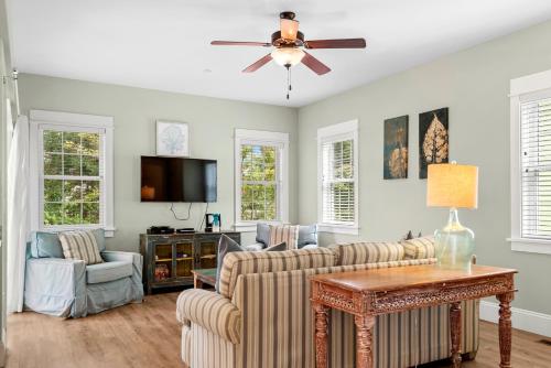 a living room with a couch and a ceiling fan at Bay Breeze in Kill Devil Hills