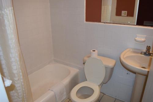 a bathroom with a toilet and a sink at Friendship Motor Inn Carneys Point - Pennsville in Cedar Crest Manor