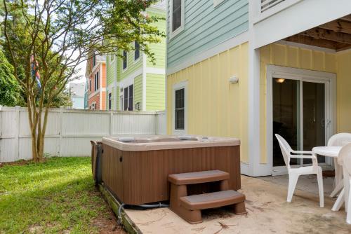 a hot tub sitting on the side of a house at Bay Breeze in Kill Devil Hills