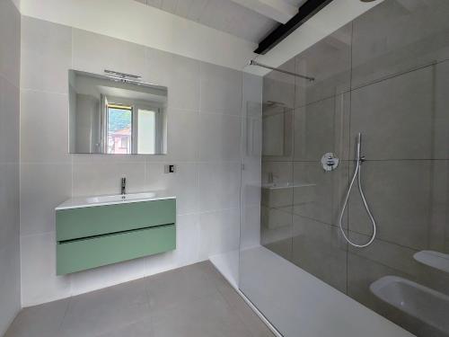 a white bathroom with a sink and a shower at Urban Living in Como