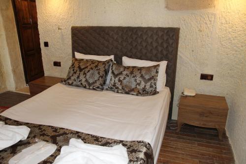 a bedroom with a large bed with pillows on it at Zen Cappadocia House in Goreme