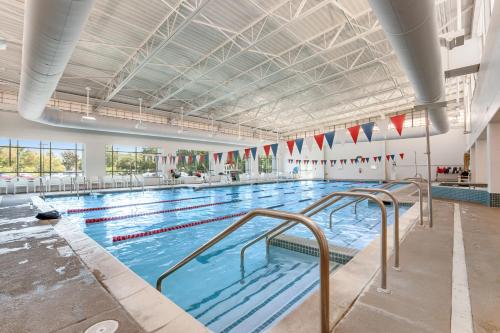 a large indoor swimming pool with blue water at Sea Colony - 908 Dover House Rd in Bethany Beach