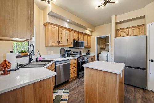 a kitchen with wooden cabinets and a stainless steel refrigerator at Panorama Peak Mountain Hideaway in Custer
