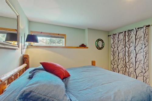 a bedroom with a bed and a clock on the wall at Mountain View Apartment in Eagle