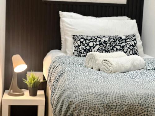 Un dormitorio con una cama con toallas. en Nomad Nook Room in Tecom Barsha Heights, en Dubái