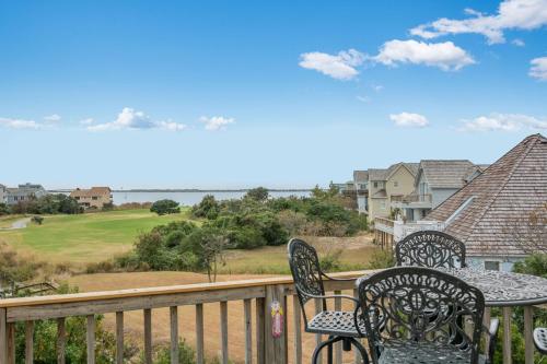 a patio with two chairs and a table on a balcony at Baymeadow 10 in Nags Head