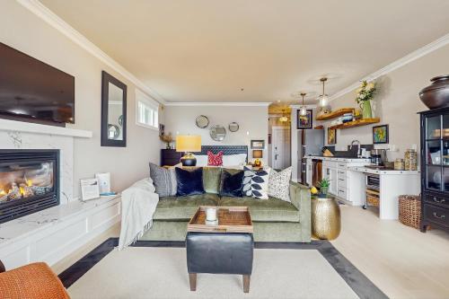 a living room with a couch and a kitchen at The Beach Suite in Langley